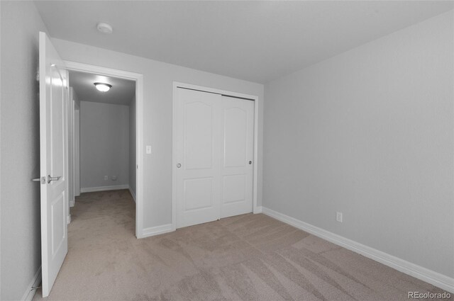 7436 Centennial Glen Dr, Colorado Springs, CO 80919 - unfurnished bedroom with light colored carpet, a closet, and baseboards
