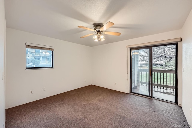 carpeted empty room featuring a ceiling fan