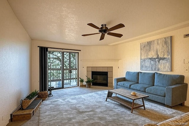 10293 E Peakview Ave Unit F104, Englewood, CO 80111 - living area with carpet, ceiling fan, a tile fireplace, and a textured wall