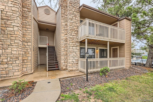 10293 E Peakview Ave Unit F104, Englewood, CO 80111 - doorway to property featuring a balcony, covered porch, and a chimney