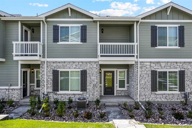 161 Robin Rd, Johnstown, CO 80534 - multi unit property featuring stone siding, central AC unit, board and batten siding, and a balcony
