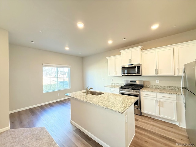 161 Robin Rd, Johnstown, CO 80534 - kitchen with a sink, appliances with stainless steel finishes, white cabinets, and light wood finished floors