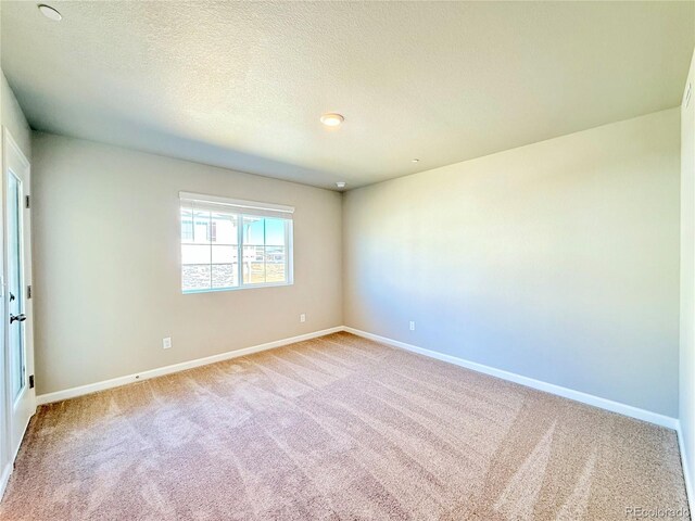 161 Robin Rd, Johnstown, CO 80534 - empty room featuring a textured ceiling, baseboards, and carpet
