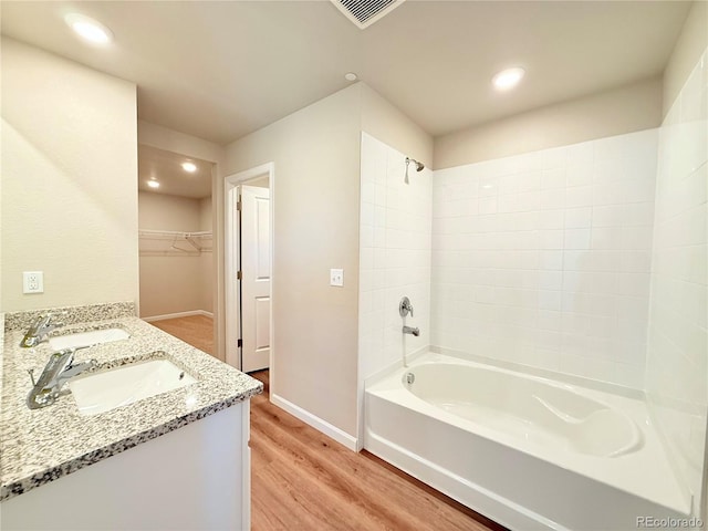 161 Robin Rd, Johnstown, CO 80534 - full bathroom with visible vents, wood finished floors, shower / tub combination, and a sink