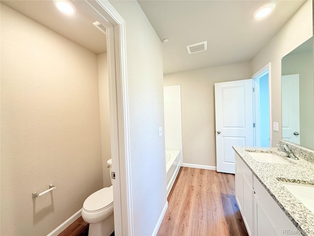 161 Robin Rd, Johnstown, CO 80534 - bathroom with toilet, wood finished floors, visible vents, and a sink