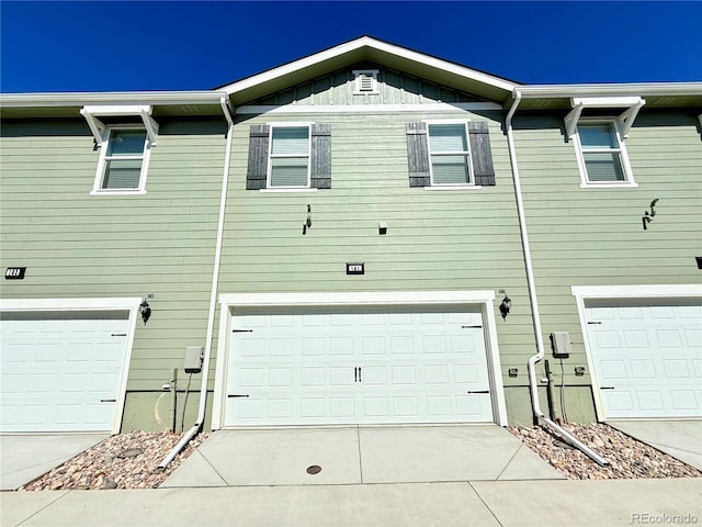 161 Robin Rd, Johnstown, CO 80534 - townhome / multi-family property featuring an attached garage and driveway