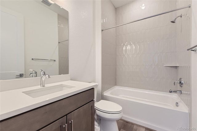 full bathroom featuring toilet, vanity, tiled shower / bath, and hardwood / wood-style flooring