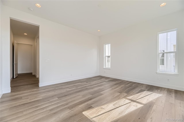 empty room with light hardwood / wood-style flooring