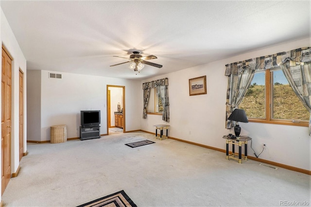 unfurnished living room with light carpet and ceiling fan