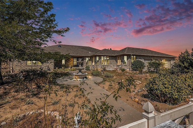 view of back house at dusk