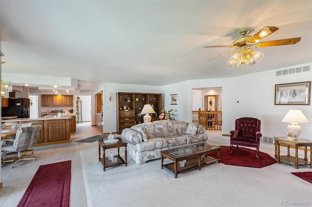 living room featuring ceiling fan and light tile patterned flooring