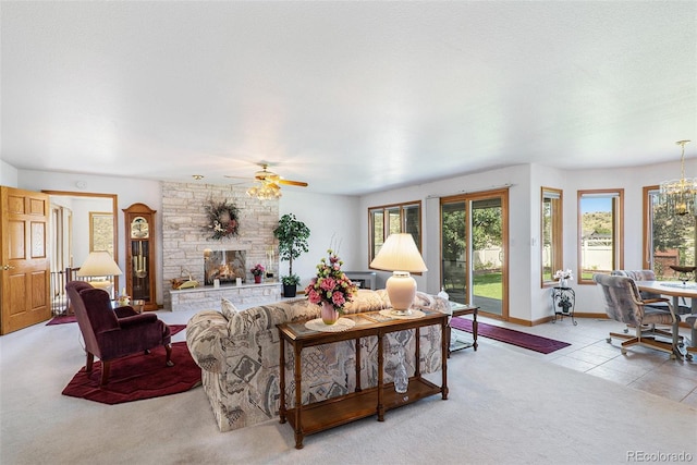 living room featuring light carpet, a fireplace, and ceiling fan