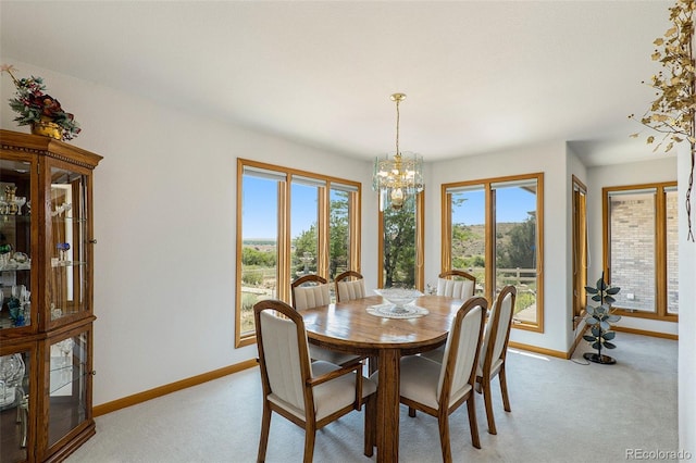 carpeted dining space featuring an inviting chandelier