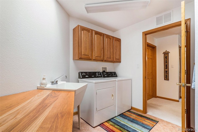 washroom featuring light colored carpet, cabinets, independent washer and dryer, and sink