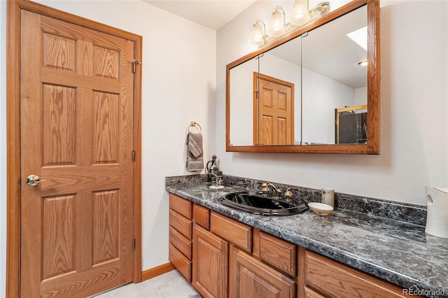 bathroom with tile patterned floors and vanity