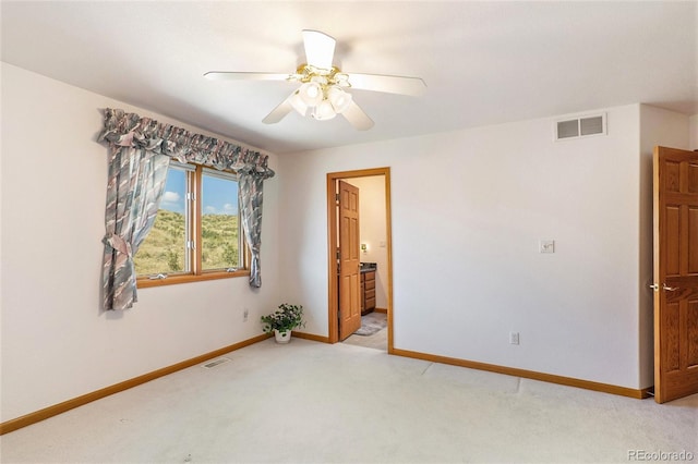 carpeted spare room with ceiling fan