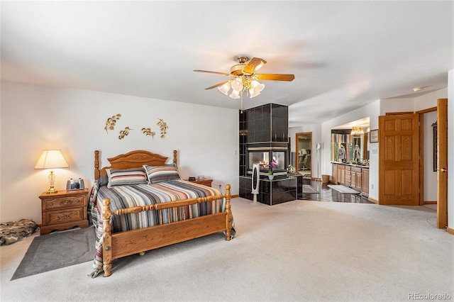 bedroom with ceiling fan, carpet floors, and ensuite bathroom