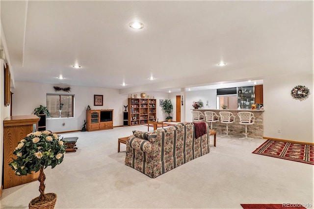 carpeted living room with bar area