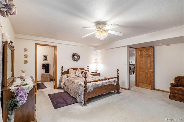 bedroom with light carpet, a textured ceiling, ensuite bathroom, and ceiling fan