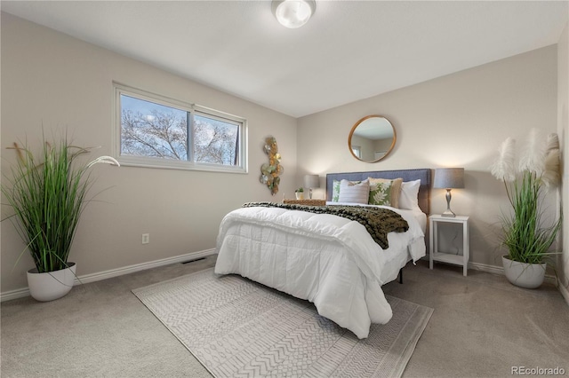carpeted bedroom featuring baseboards