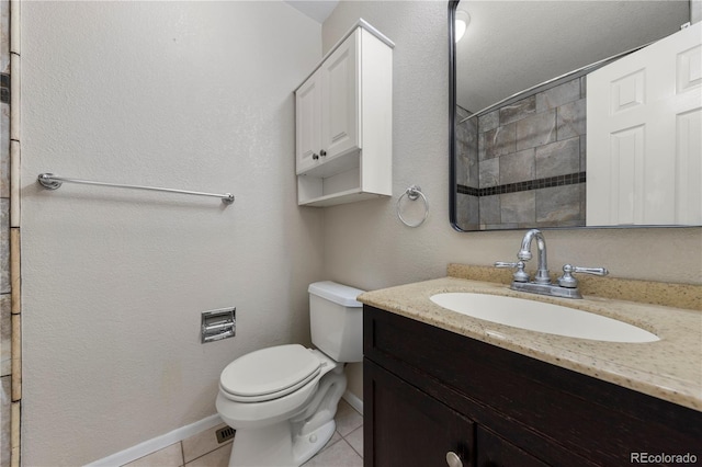bathroom featuring toilet, baseboards, tile patterned flooring, and vanity