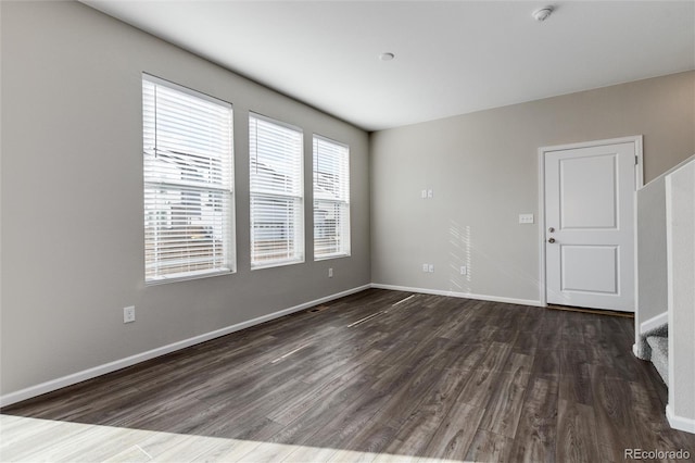 spare room featuring dark hardwood / wood-style flooring