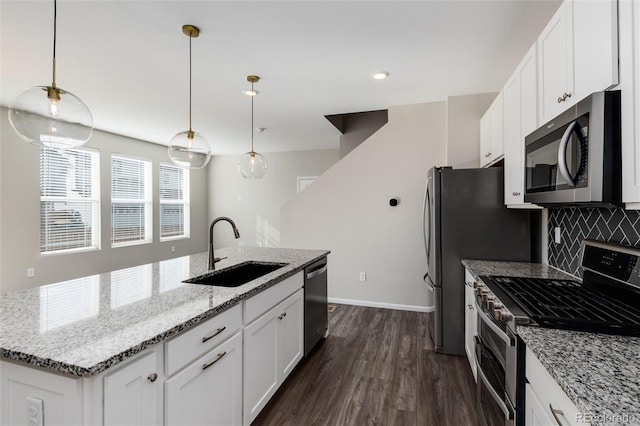 kitchen featuring white cabinets, an island with sink, sink, appliances with stainless steel finishes, and dark hardwood / wood-style floors