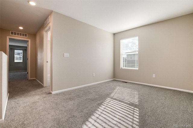 unfurnished room featuring carpet