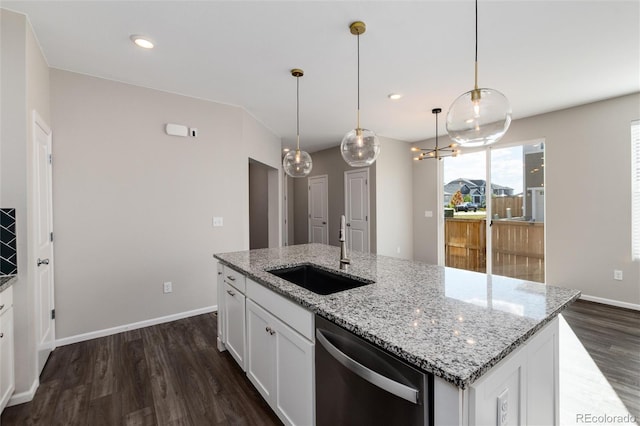 kitchen featuring white cabinets, dishwasher, hanging light fixtures, and sink