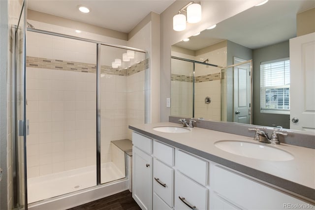 bathroom with vanity, wood-type flooring, and a shower with shower door