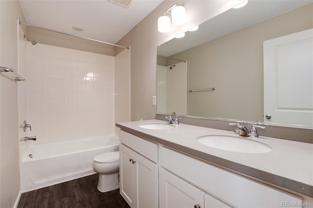 full bathroom with shower / washtub combination, vanity, toilet, and hardwood / wood-style flooring