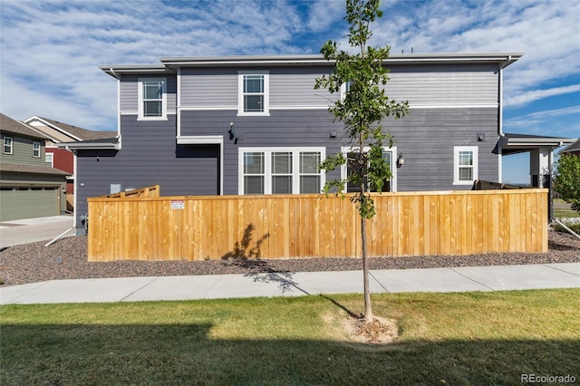 view of front of house with a garage and a front lawn