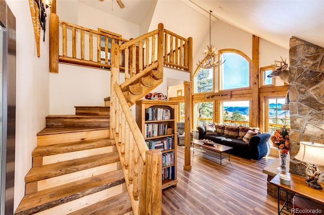 31266 Half Peak Trl, Pine, CO 80470 - stairway featuring high vaulted ceiling, wood finished floors, and ceiling fan