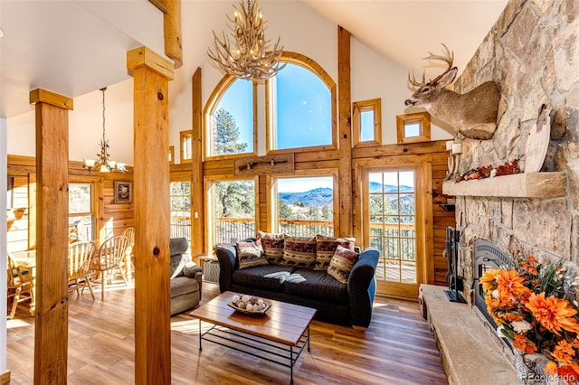 31266 Half Peak Trl, Pine, CO 80470 - living room with a chandelier, high vaulted ceiling, wood finished floors, and a fireplace