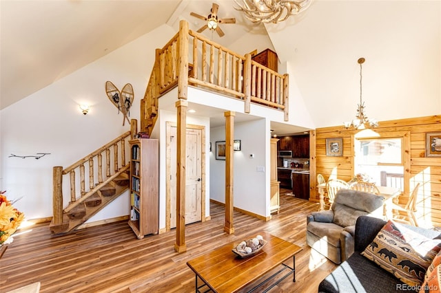 31266 Half Peak Trl, Pine, CO 80470 - living room with stairway, high vaulted ceiling, light wood-style floors, baseboards, and a ceiling fan
