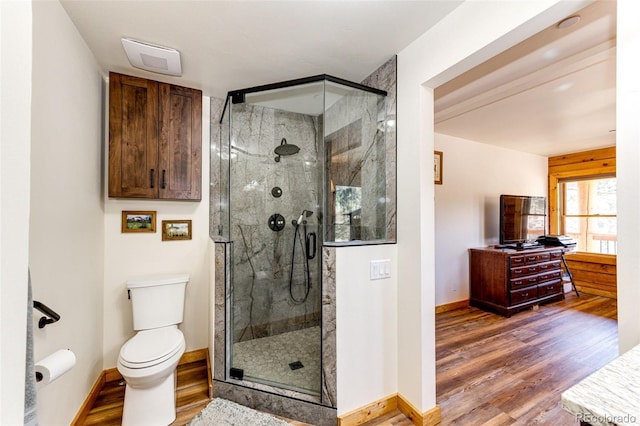 31266 Half Peak Trl, Pine, CO 80470 - bathroom with wood finished floors, a shower stall, toilet, baseboards, and vanity