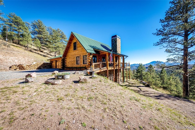 31266 Half Peak Trl, Pine, CO 80470 - view of side of home with a chimney, log exterior, a deck with mountain view, and metal roof