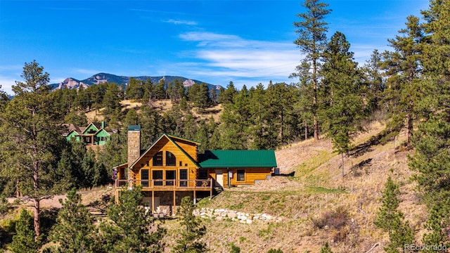 31266 Half Peak Trl, Pine, CO 80470 - back of property with a chimney, a deck with mountain view, and log siding