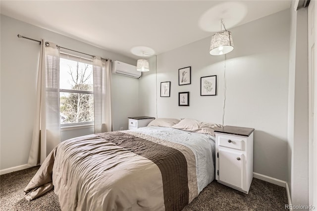 bedroom featuring an AC wall unit, dark colored carpet, and baseboards