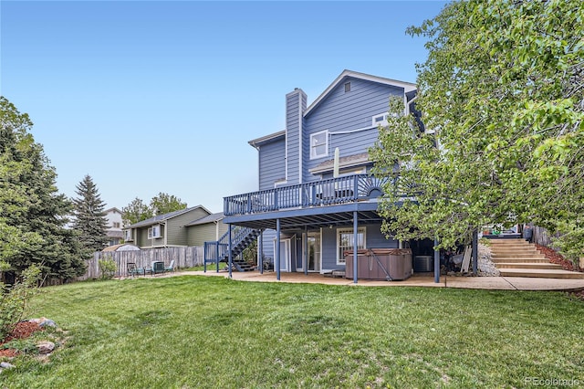 back of house with stairs, a hot tub, a patio area, a deck, and central AC