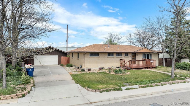 ranch-style house featuring brick siding, a front yard, an outdoor structure, a deck, and a detached garage