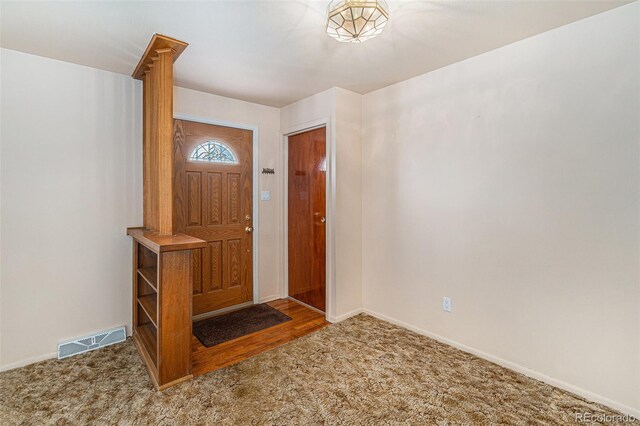 carpeted entrance foyer featuring baseboards