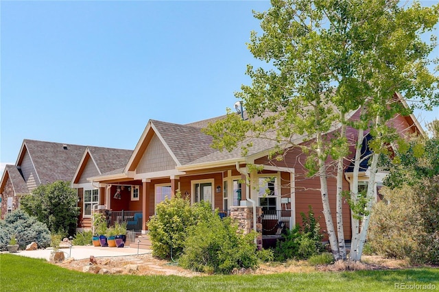 34827 E 7th Ave, Watkins, CO 80137 - view of front of house featuring a porch and roof with shingles