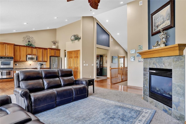34827 E 7th Ave, Watkins, CO 80137 - living room with high vaulted ceiling, ceiling fan, light wood-style floors, recessed lighting, and a fireplace
