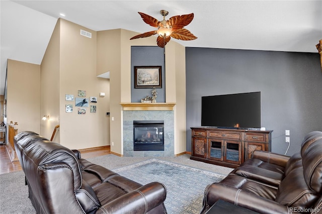 34827 E 7th Ave, Watkins, CO 80137 - living area featuring ceiling fan, a tile fireplace, carpet floors, and lofted ceiling