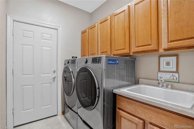 34827 E 7th Ave, Watkins, CO 80137 - washroom featuring washing machine and clothes dryer, cabinet space, and light tile patterned floors