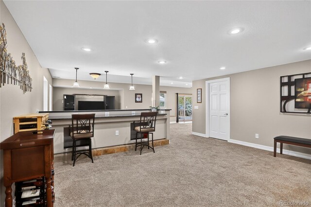 34827 E 7th Ave, Watkins, CO 80137 - kitchen featuring carpet floors, recessed lighting, a kitchen bar, decorative light fixtures, and a peninsula