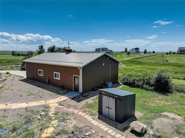 34827 E 7th Ave, Watkins, CO 80137 - view of side of home featuring an outbuilding, a view of rural / pastoral area, and a metal roof