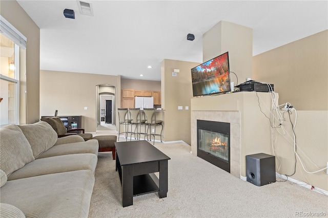 living area with recessed lighting, visible vents, carpet flooring, a tile fireplace, and baseboards