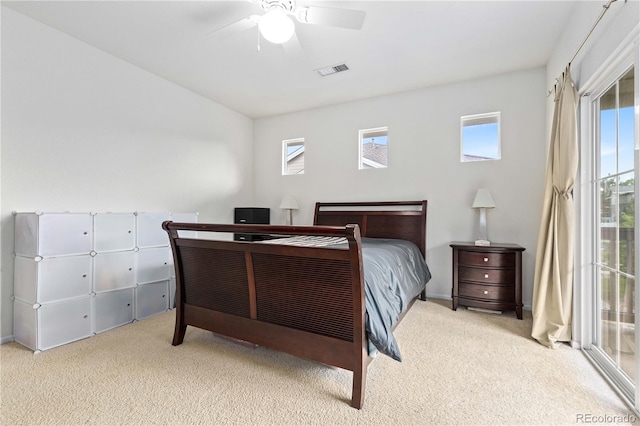 carpeted bedroom with ceiling fan, visible vents, and access to exterior